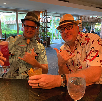 Friends in Hawaiian Shirts enjoying an beverage